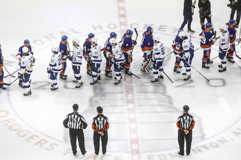 Tampa Bay Lightning and the New York Islanders players shake hands after the Lightning won in overtime of Game 6 of the NHL hockey Eastern Conference final, Thursday, Sept. 17, 2020, in Edmonton, Alberta. (Jason Franson/The Canadian Press via AP)