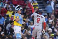 Washington Nationals' Eddie Rosario (8) celebrates after his solo home run in front of Boston Red Sox catcher Reese McGuire, left, during the fifth inning of a baseball game, Saturday, May 11, 2024, in Boston. (AP Photo/Michael Dwyer)