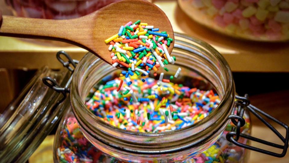 Close-Up Of Multi Colored Sprinkles In Jar