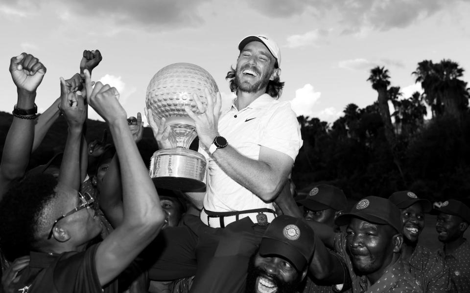  Tommy Fleetwood of England is held aloft by the green keepers at Sun City - Tearful Tommy Fleetwood fights through effects of heatstroke to end trophy drought - GETTY IMAGES/Warren Little