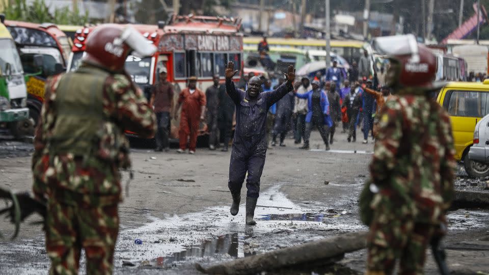 A protester raises his hands as he walks towards riot police during protests in the capital Nairobi.  - Brian Inganga/AP