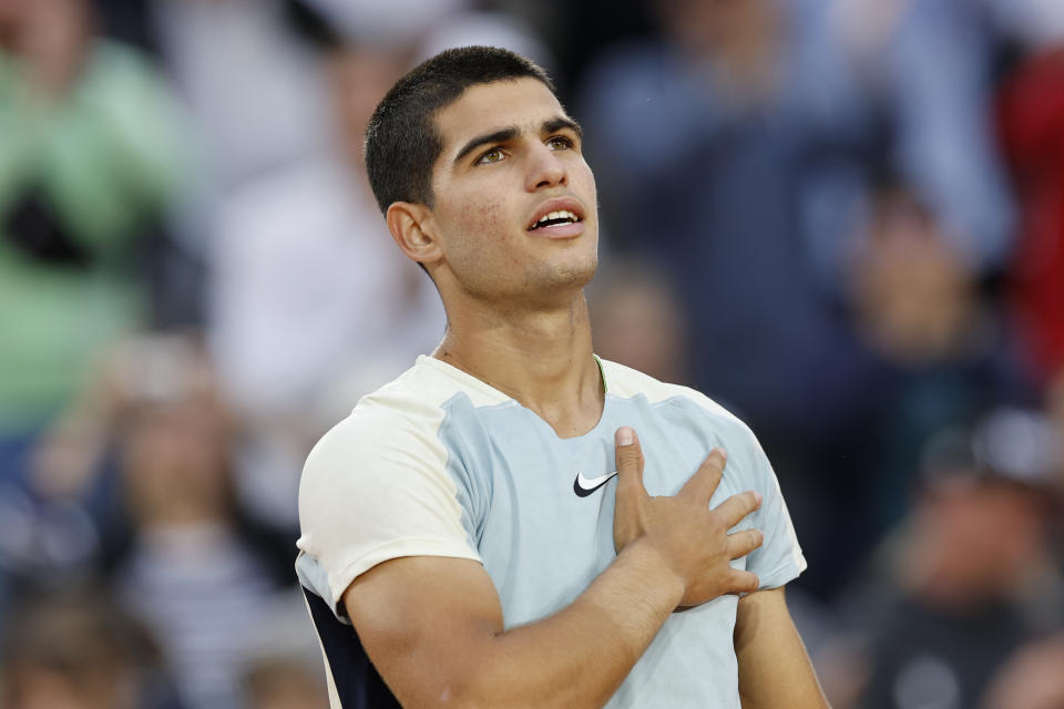 Spain's Carlos Alcaraz celebrates winning against Spain's Albert Ramos-Vinolas in five sets, 6-1, 6-7 (7-9), 5-7, 7-6 (7-2), 6-4, during their second round match at the French Open tennis tournament in Roland Garros stadium in Paris, France, Wednesday, May 25, 2022. (AP Photo/Jean-Francois Badias)