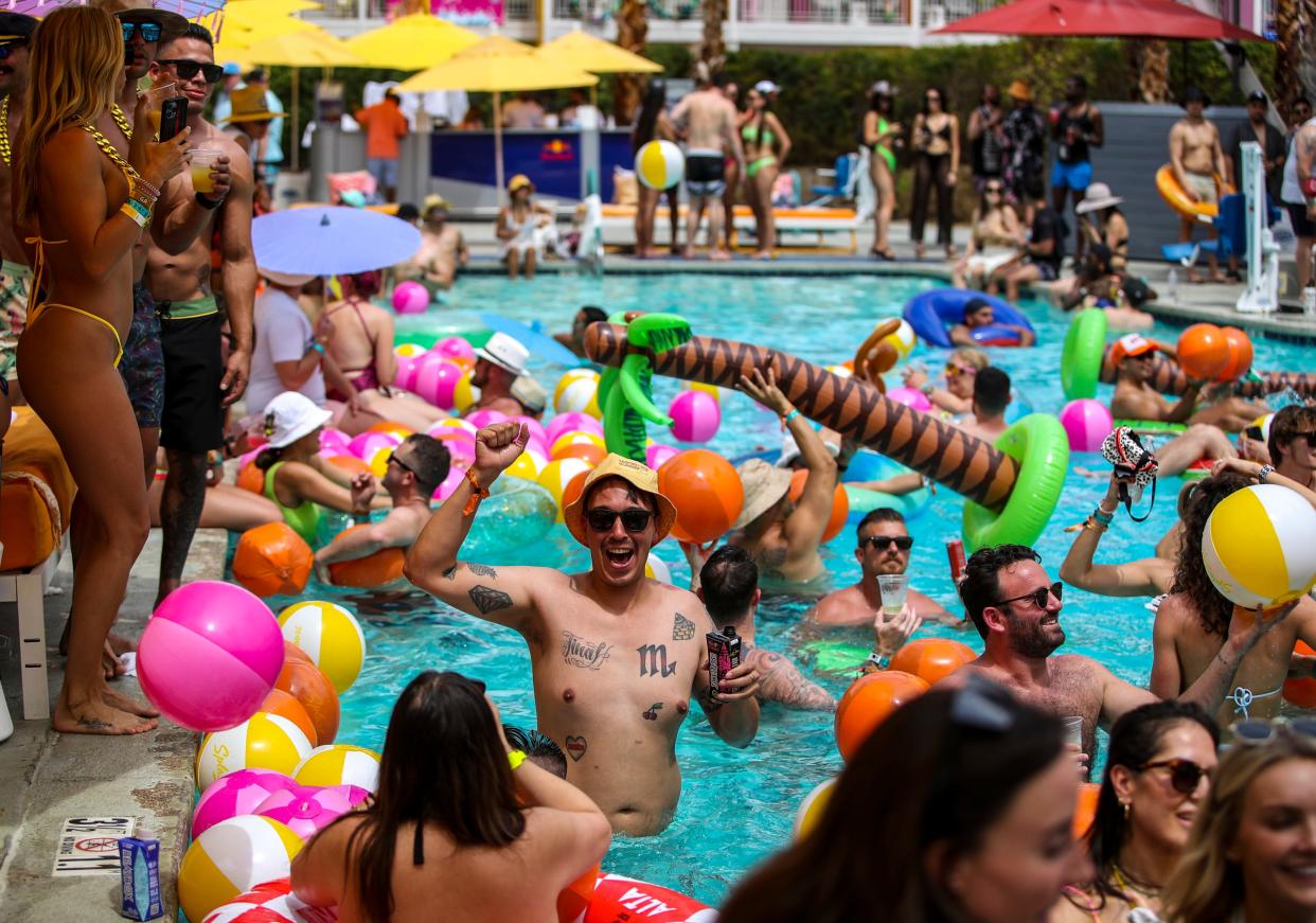 Festivalgoers dance in the pool as an artist performs at the nearby stage during Splash House at the Saguaro in Palm Springs, Calif., Saturday, June 10, 2023. 