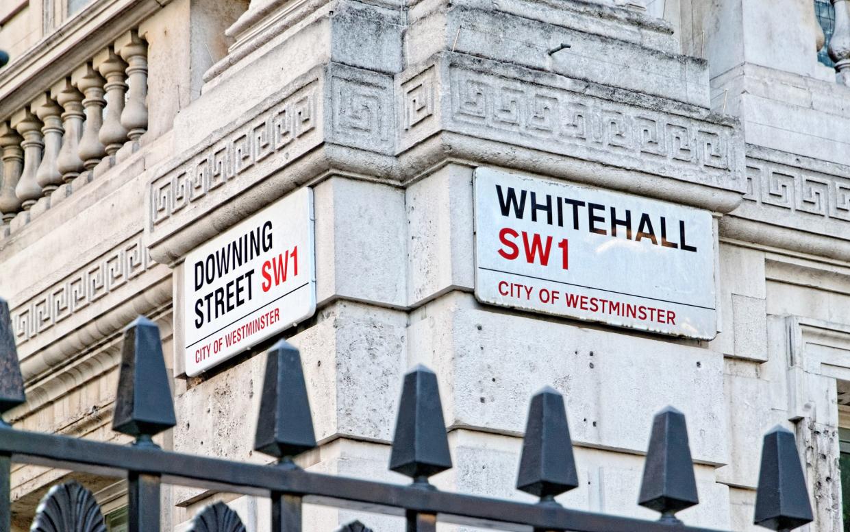 Downing Street sign hangs on building in City of Westminster