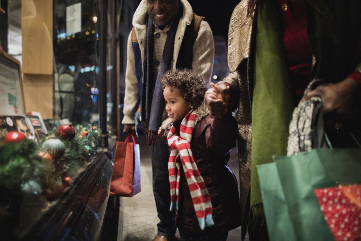 family shopping for christmas presents looking at store display