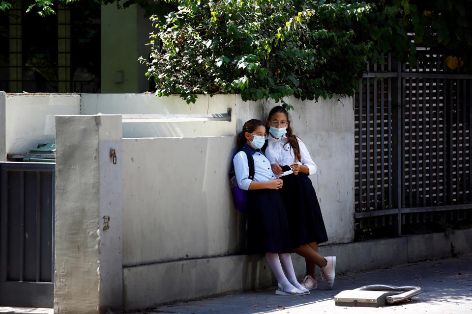 Image: Girls wearing a protective face mask look on ahead of a nationwide lockdown to contain the spread of the coronavirus disease (COVID-19), which is set to begin on Friday, in Tel Aviv, Israel (Corinna Kern / Reuters)