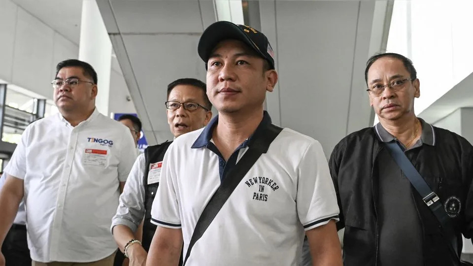 Christian Domarique (center), a crew member of the MV Tutor, arrives in Metro Manila, on June 17. Dozens of ships have been attacked in the Red Sea, as regional tensions flare over Israel's war in Gaza. - Jam Sta Rosa/AFP/Getty Images