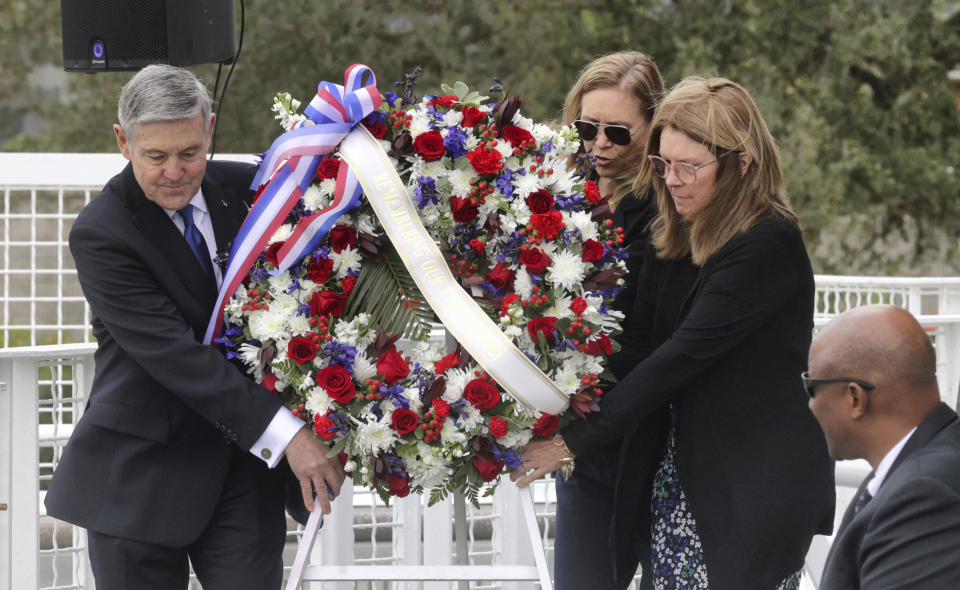 A wreath is presented by, from left, Bob Cabana, Associate Administrator of NASA; Janet Petro, NASA KSC director, and Sheryl Chaffee, daughter of Apollo 1 astronaut Roger Chaffee, during NASA's Day of Remembrance ceremony, hosted by the Astronauts Memorial Foundation at Kennedy Space Center Visitor Complex,Thursday, Jan. 26, 2023. NASA is marking the 20th anniversary of the space shuttle Columbia tragedy with somber ceremonies during its annual tribute to fallen astronauts. (Joe Burbank/Orlando Sentinel via AP)