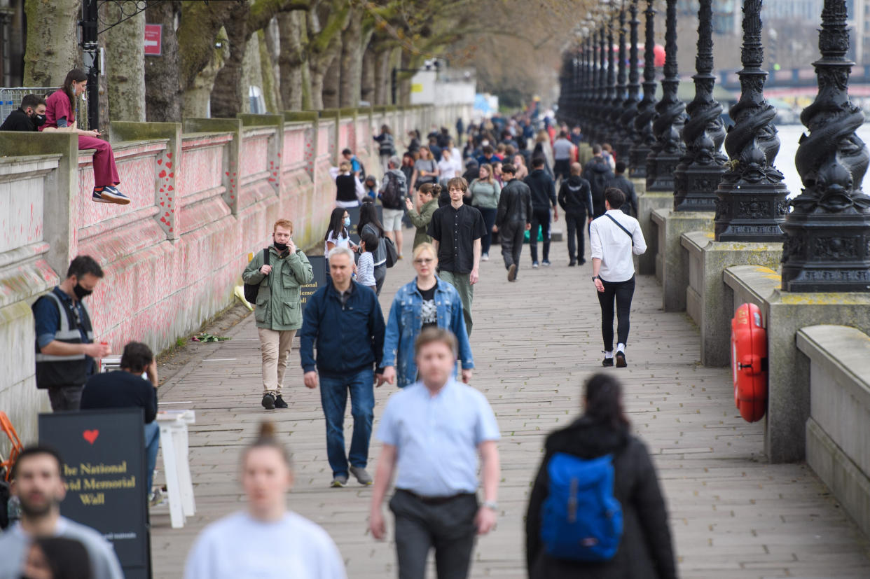 People walk past the COVID-19 Memorial Wall on the Embankment, central London, which has been painted with hearts in memory of the more than 145,000 people who have died in the UK from coronavirus. Picture date: Wednesday March 31, 2021. Photo credit should read: Matt Crossick/Empics