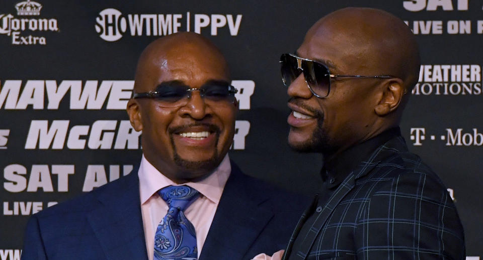 Mayweather Promotions CEO Leonard Ellerbe and Floyd Mayweather Jr. talk during a news conference at the KA Theatre at MGM Grand Hotel & Casino on Aug. 23, 2017 in Las Vegas, Nevada. (Getty Images)