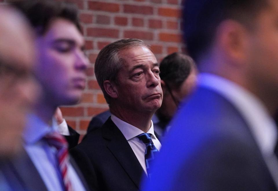 Nigel Farage listens to Tory speakers at the Popular Conservatism launch (PA)