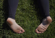 Maeleene Jessop lies face down on the grass during an integration circle at an ayahuasca retreat in Hildale, Utah, on Saturday, Oct. 15, 2022. Following each of the three ayahuasca ceremonies, Hummingbird Church asks their participants to partake in integration, or a group reflection and discussion, to help interpret messages they received from the ayahuasca. (AP Photo/Jessie Wardarski)