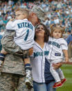 <p>Anna Kitchens (2R), son Caleb Kitchens (L), 4, and daughter Allie Kitchens, 19 months, react to a surprise reunion as Anna’s husband, Technical Sergeant Donald Kitchens of the U.S. Air Force arrives home from his duty in Turkey two weeks early, prior to the game between the Seattle Mariners and the Milwaukee Brewers at Safeco Field on August 9, 2013 in Seattle, Washington. (Photo by Otto Greule Jr/Getty Images) </p>