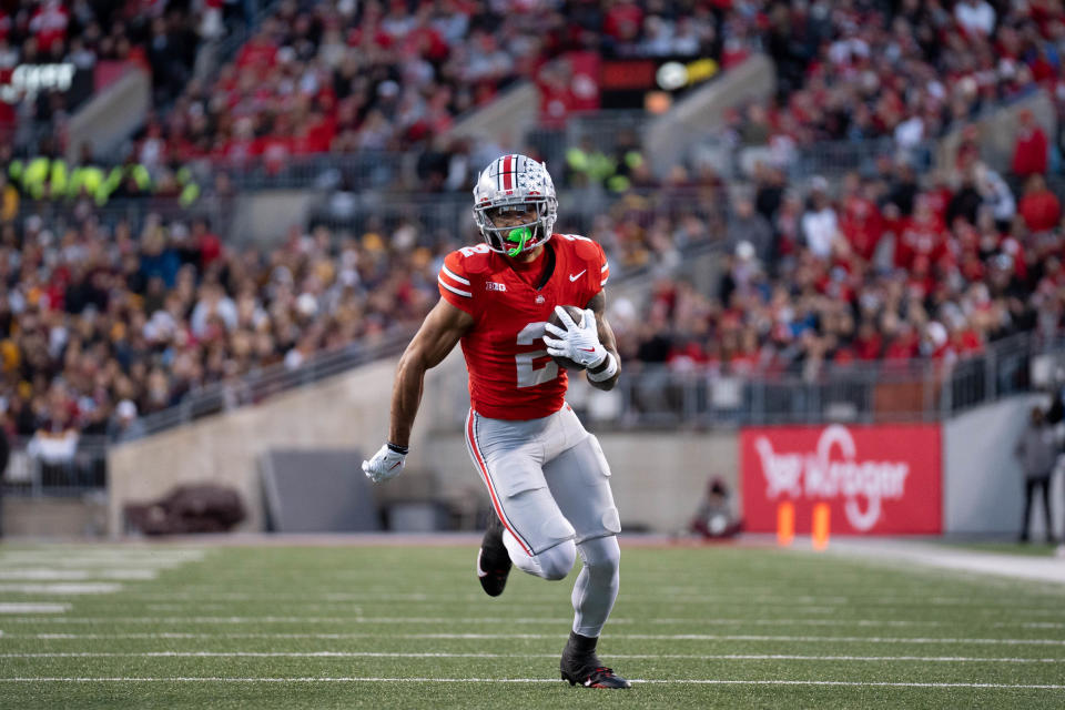 Nov 18, 2023; Columbus, Ohio, USA; 
Ohio State Buckeyes wide receiver Emeka Egbuka (2) runs down the field earning a first down against the Minnesota Golden Gophers during the first half of their game on Saturday, Nov. 18, 2023 at Ohio Stadium.