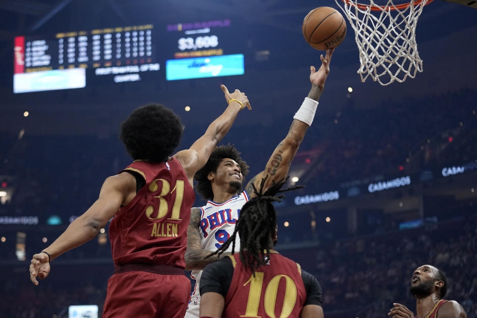 Philadelphia 76ers guard Kelly Oubre Jr. (9) shoots in front of Cleveland Cavaliers center Jarrett Allen (31) and guard Darius Garland (10) in the first half of an NBA basketball game, Monday, Feb. 12, 2024, in Cleveland. (AP Photo/Sue Ogrocki)