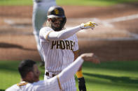 San Diego Padres' Fernando Tatis Jr. reacts after scoring from third on a single by Tommy Pham during the third inning of the team's National League wild-card series baseball game against the St. Louis Cardinals, Wednesday, Sept. 30, 2020, in San Diego. (AP Photo/Gregory Bull)