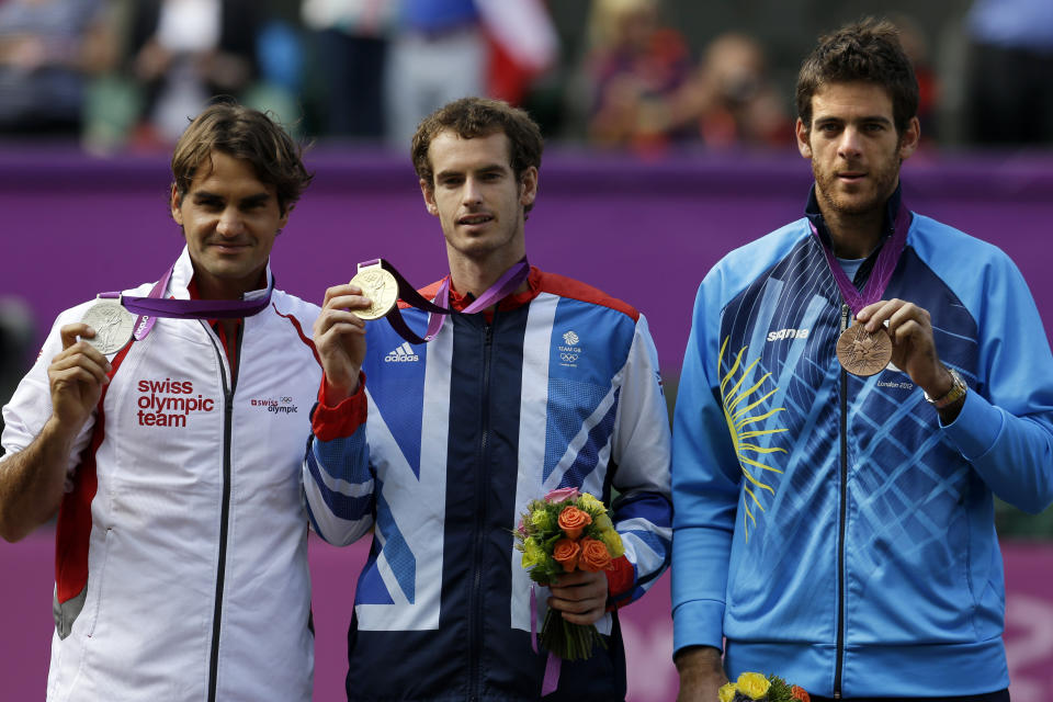 FILE - From left, silver medalist Switzerland's Roger Federer, gold medalist Andy Murray of Great Britain, and bronze medalist Juan Martin del Potro of Argentina stand during the medal ceremony of the men's singles event at the All England Lawn Tennis Club at Wimbledon, in London, at the 2012 Summer Olympics, Sunday, Aug. 5, 2012. (AP Photo/Elise Amendola, File)