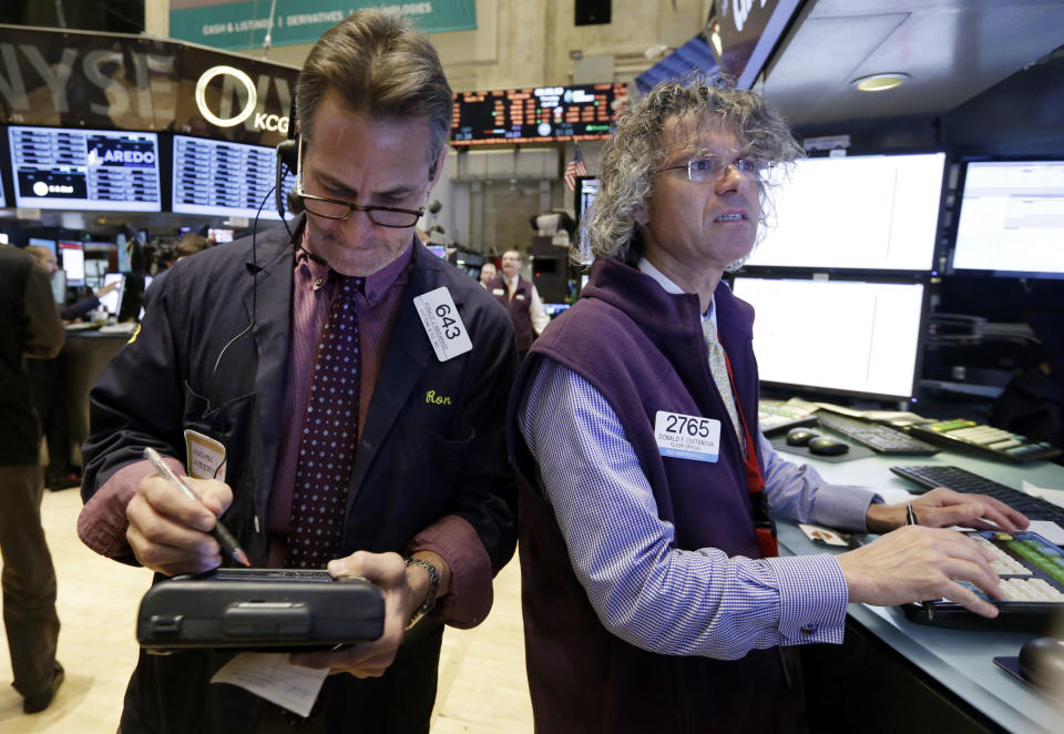 Trader Ronald Madarasz, left, and specialist Donald Civitanova work on the floor of the New York Stock Exchange Thursday, April 10, 2014. U.S. stock indexes are slipping lower in early trading Thursday as investors pick over a mixed batch of corporate earnings reports. (AP Photo/Richard Drew)