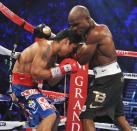 Timothy Bradley (R) of the US attempts to bull Manny Pacquiao (L) of the Philippines into the ropes during their WBO welterweight title match at the MGM Grand Arena on June 9, 2012 in Las Vegas, Nevada. Unbeaten Bradley ended Pacquiao's long unbeaten run with a controversial split decision victory over the Filipino ring icon. AFP PHOTO / JOE KLAMARJOE KLAMAR/AFP/GettyImages