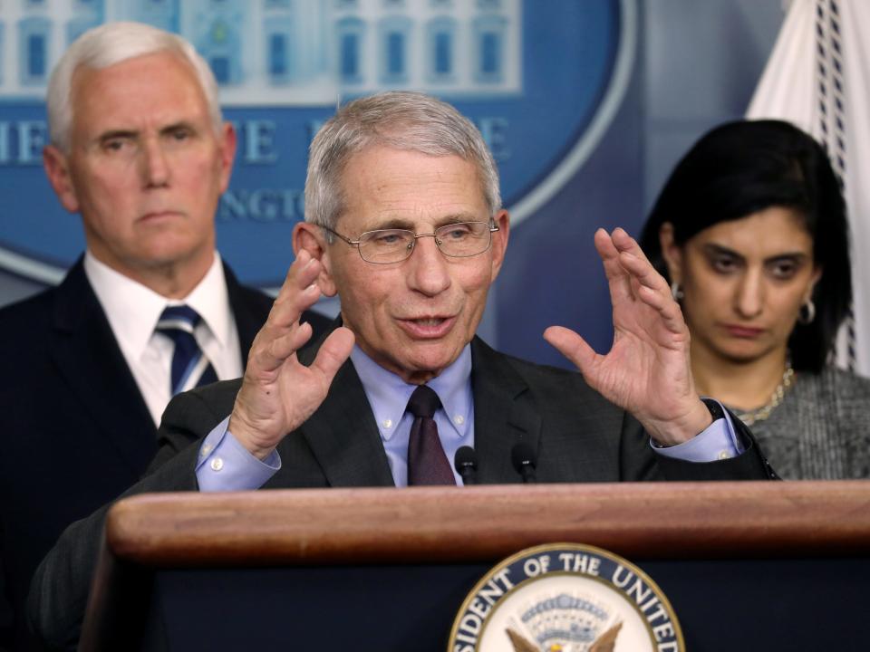 FILE PHOTO: Vice President Mike Pence listens to Anthony Fauci, director of the NIH National Institute of Allergy and Infectious Diseases, as he answers a question from the media after Pence gave a news briefing about the coronavirus with members of the White House coronavirus task force at the White House in Washington, U.S. March 3, 2020. REUTERS/Leah Millis/File Photo