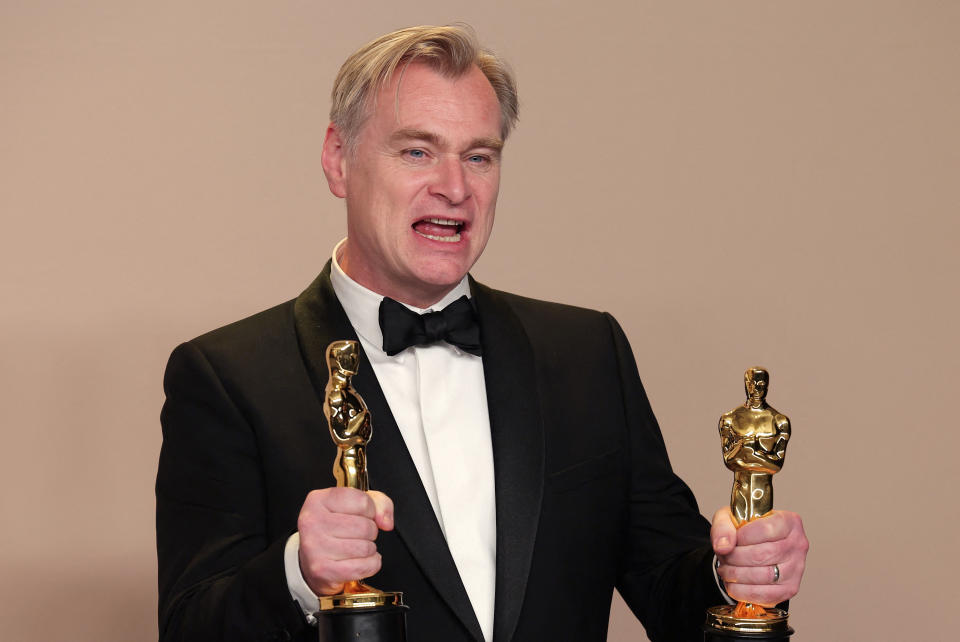 Christopher Nolan poses with the Oscar for Best Picture and Best Director Oscar for "Oppenheimer", in the Oscars photo room at the 96th Academy Awards in Hollywood, Los Angeles, California, U.S., March 10, 2024. REUTERS/Carlos Barria