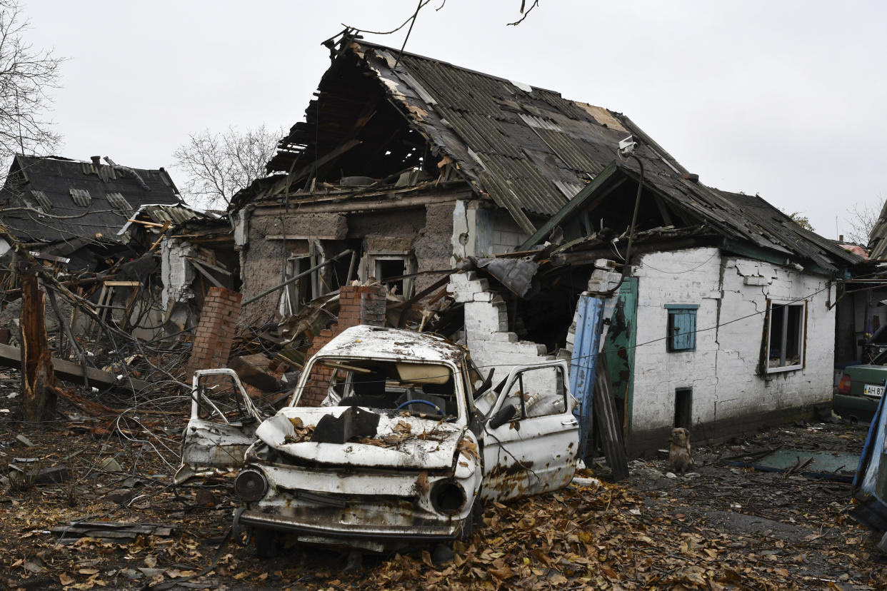 A damaged Soviet-era Ukrainian car "Zaporozhets" is seen next to a destroyed apartment building after Russian shelling in Pokrovsk, Donetsk region, Ukraine, Friday, Nov. 4, 2022. (AP Photo/Andriy Andriyenko)