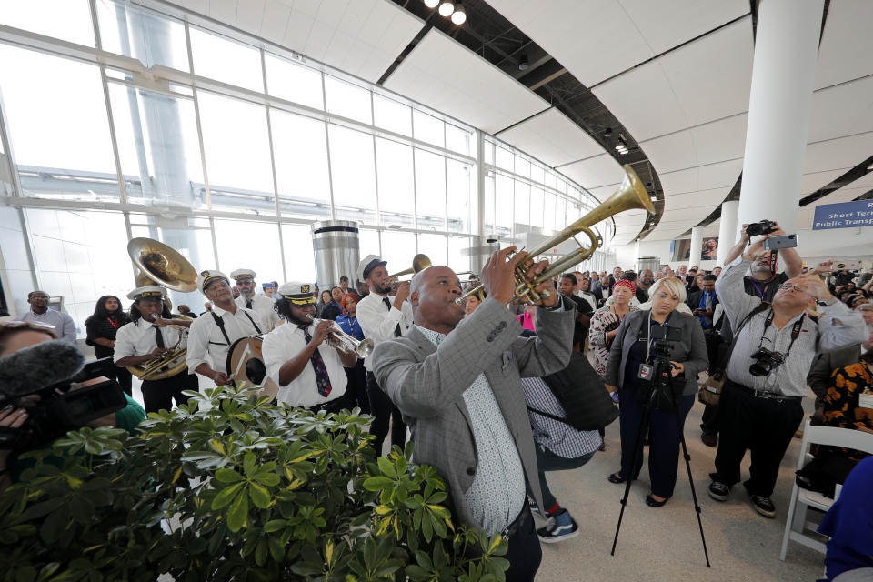 CORRECTS CITY TO KENNER, NOT BATON ROUGE- New Orleans trumpeter James Andrews leads a brass band at a ribbon cutting ceremony opening the newly built main terminal of the Louis Armstrong New Orleans International Airport in Kenner, La., Tuesday, Nov. 5, 2019. (AP Photo/Gerald Herbert)