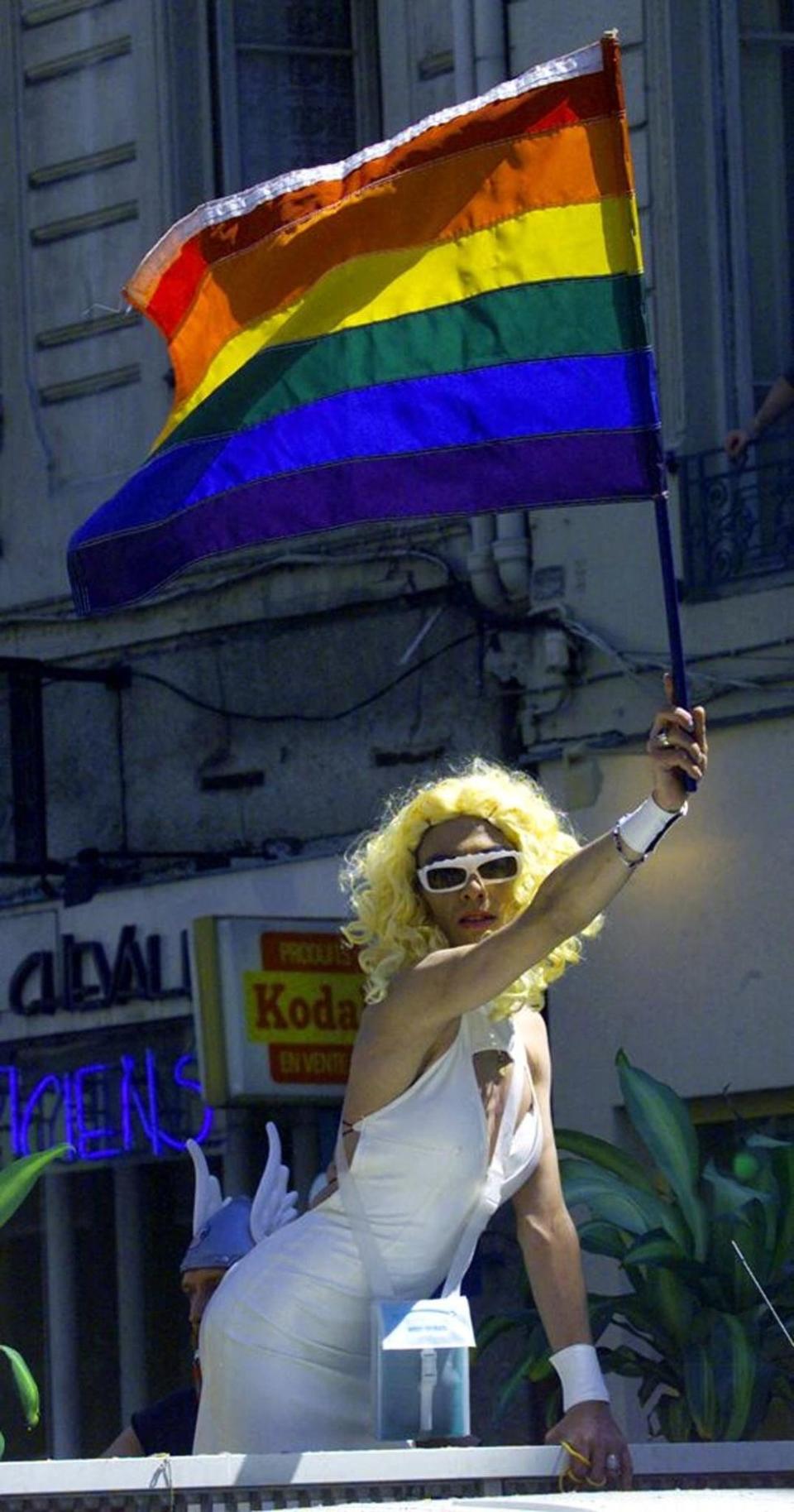 drag queen holding pride flag pride