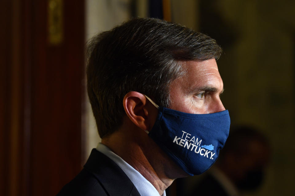 Kentucky Governor Andy Beshear speaks to reporters following the signing of bills related to the American Rescue Plan Act at the Kentucky State Capitol in Frankfort, Ky., Wednesday, April 7, 2021. (AP Photo/Timothy D. Easley)