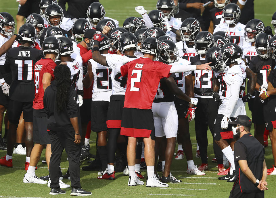 The Atlanta Falcons, led by quarterback Matt Ryan (2), take the field to begin NFL football training camp practice Saturday, Aug. 15, 2020, in Flowery Branch, Ga. (Curtis Compton/Atlanta Journal-Constitution via AP)