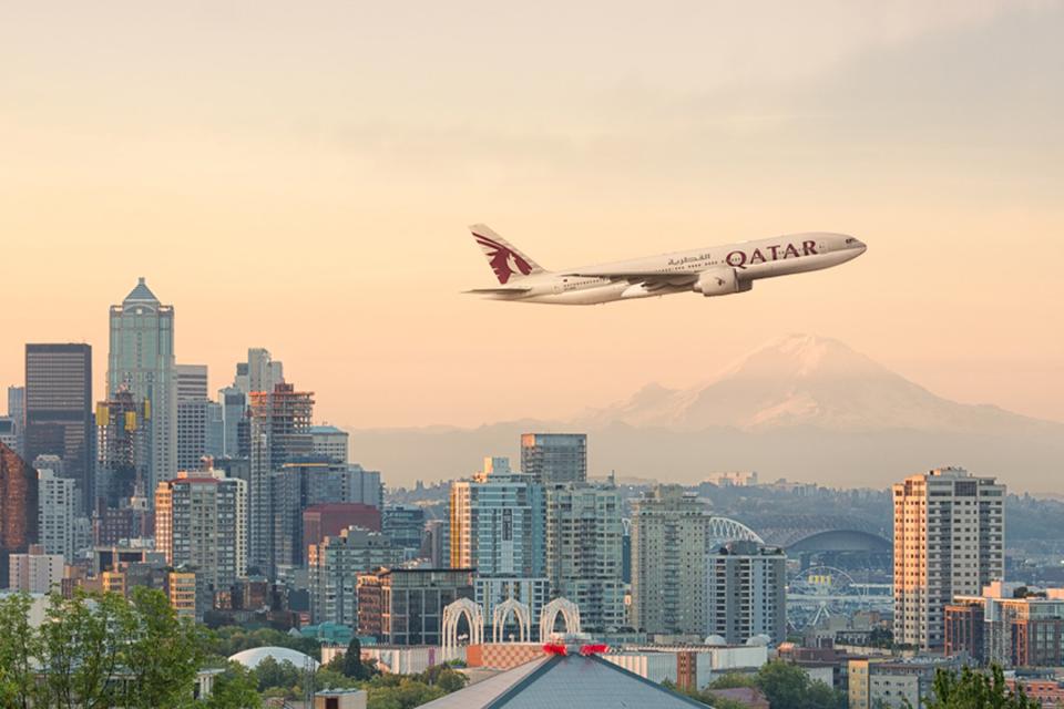 Qatar Airways plane flying over a city