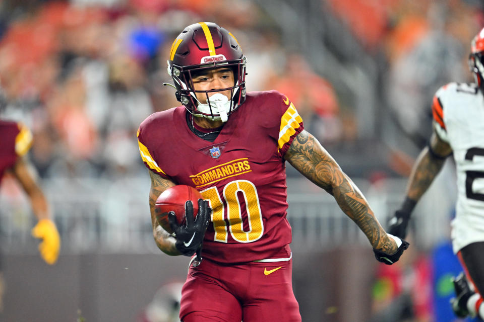 Wide receiver Kazmeir Allen #10 of the Washington Commanders runs back a punt return. (Photo by Jason Miller/Getty Images)