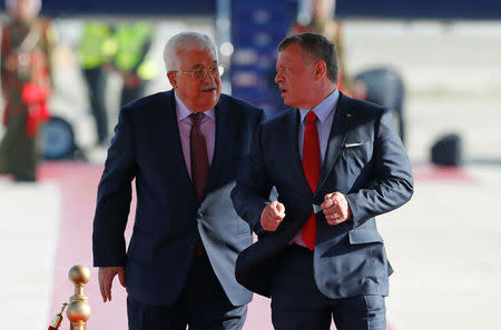 Jordan's King Abdullah II welcomes Palestinian President Mahmoud Abbas (L) during a reception ceremony at the Queen Alia International Airport in Amman, Jordan March 28, 2017. REUTERS/Muhammad Hamed