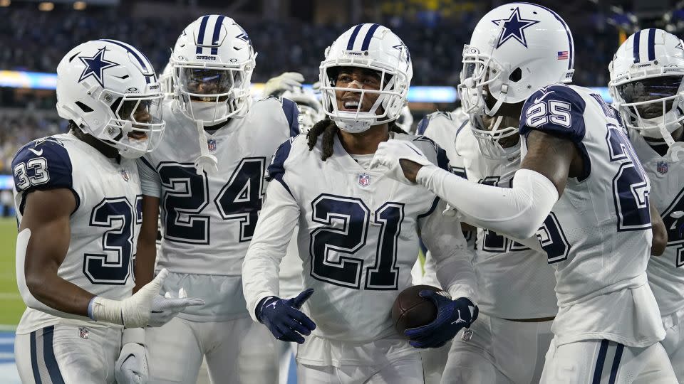 Dallas Cowboys cornerback Stephon Gilmore celebrates with his teammates after intercepting a pass during the fourth quarter against the Los Angeles Chargers. - Ashley Landis/AP