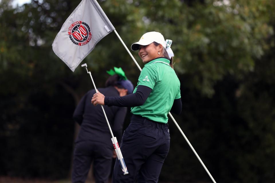 Dublin Jerome's Audrey Ryu looks toward her teammates after making a birdie on No. 18, a shot that secured Division I state medalist honors Oct. 23 at Ohio State's Gray Course.