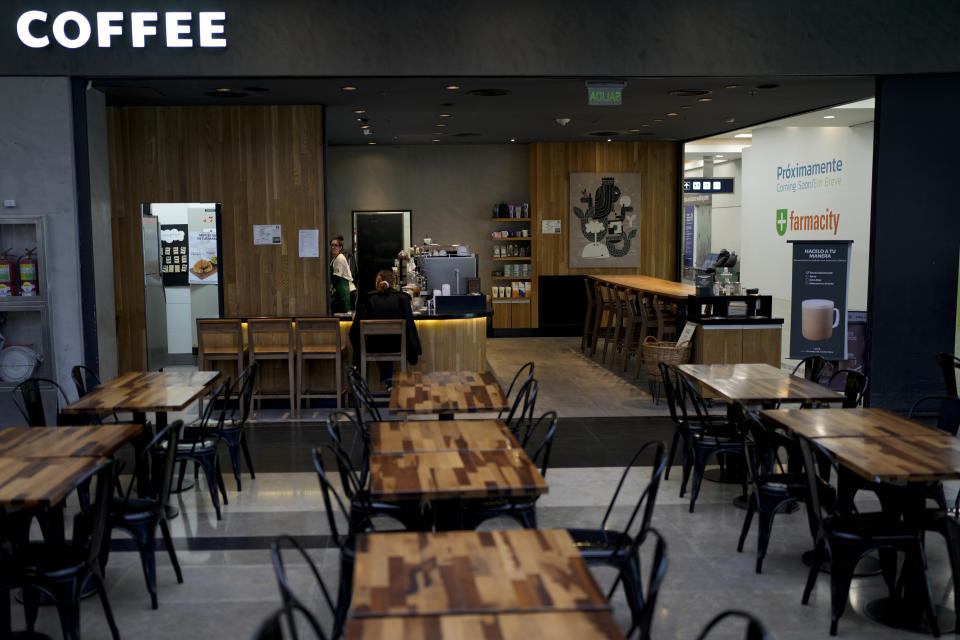 Tables are empty at a cafe that is open for business at Jorge Newbery International Airport during a general strike against the reforms of President Javier Milei in Buenos Aires, Argentina, Thursday, May 9, 2024. (AP Photo/Natacha Pisarenko)