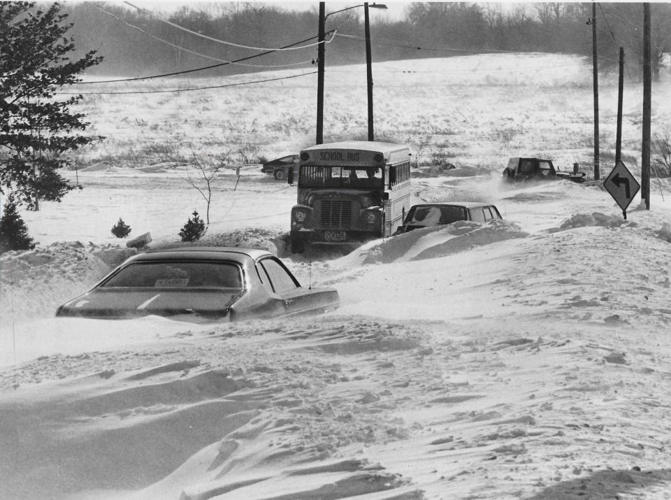 A school bus and automobiles are stuck in snowdrifts Jan. 28, 1977, on Mount Pleasant Street Northwest in Jackson Township during the Blizzard of 1977.