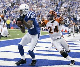 Indianapolis wide receiver Marvin Harrison (left) makes a 1-yard touchdown reception in front of Cincinnati’s Deltha O’Neal during the third quarter of the Colts’ win at the RCA Dome in Indianapolis Monday night.Darron Cummings | Associated Press