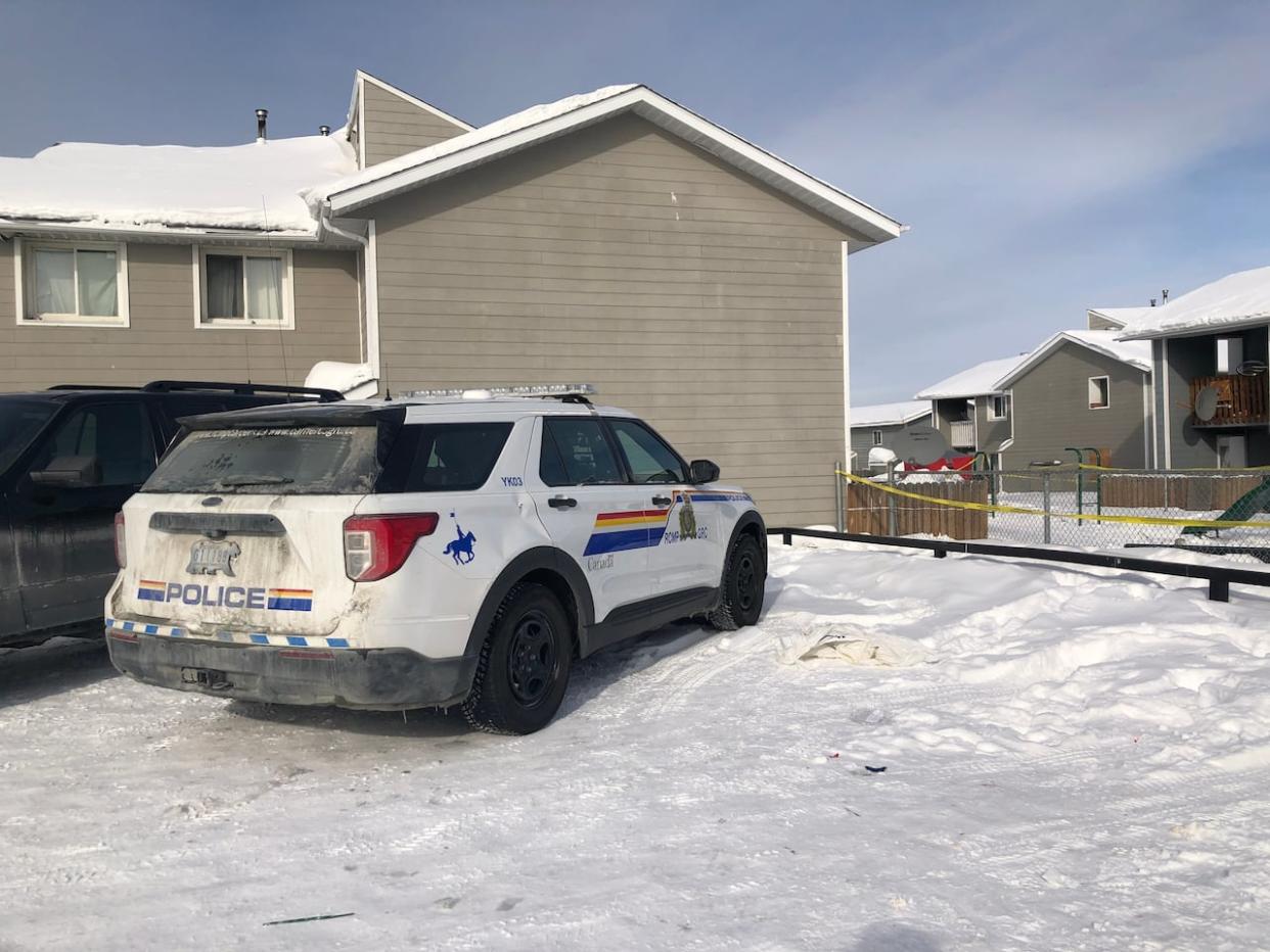 Two police cruisers were parked on Bigelow Crescent as officers canvassed the street early on Saturday afternoon. (Sarah Krymalowski/CBC - image credit)