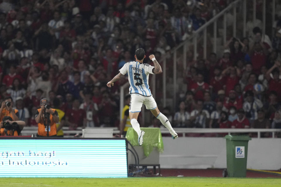 Argentina's Leandro Paredes leaps as he celebrates after scoring a goal against Indonesia during their friendly soccer match at Gelora Bung Karno Main Stadium in Jakarta, Indonesia, Monday, June 19, 2023. (AP Photo/Tatan Syuflana)