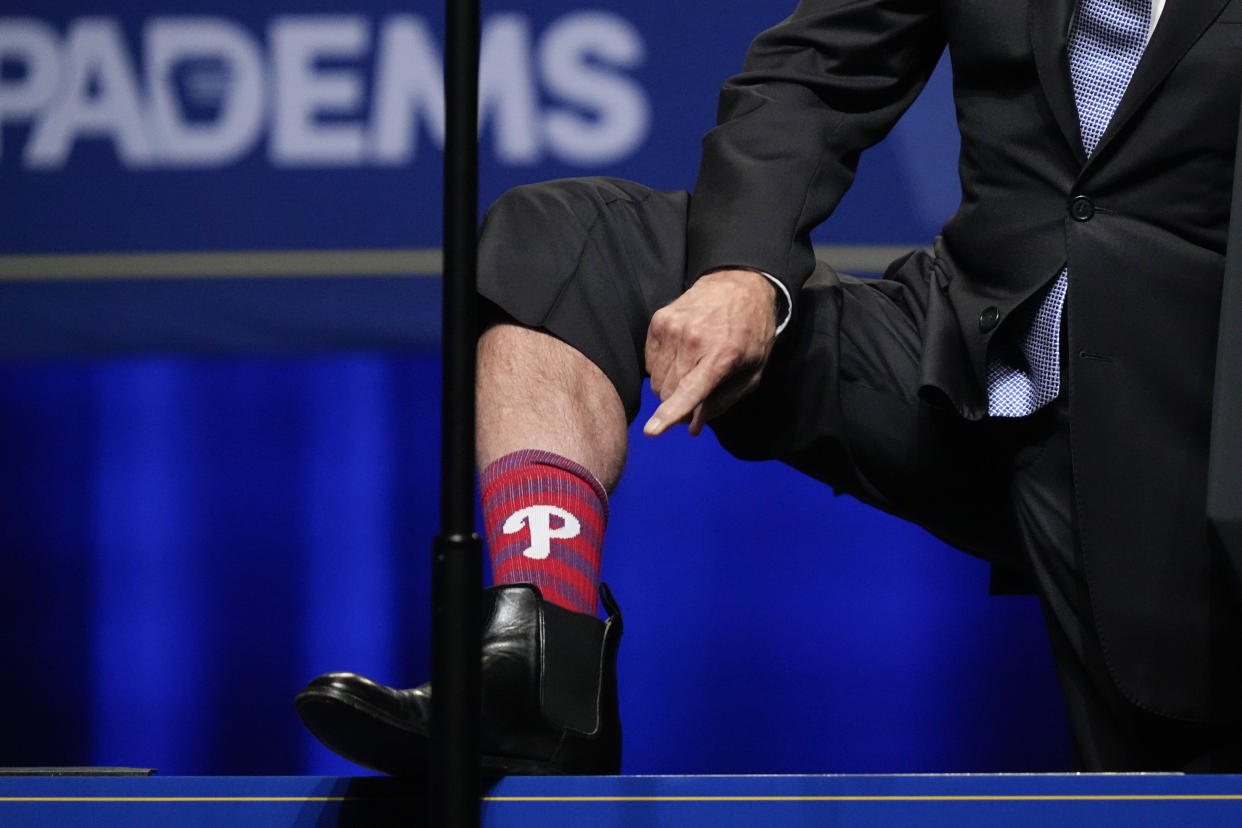 President Joe Biden shows off his Philadelphia Phillies socks as he speaks during the Pennsylvania Democratic Party's 3rd Annual Independence Dinner in Philadelphia, Friday, Oct. 28, 2022. (AP Photo/Matt Rourke)