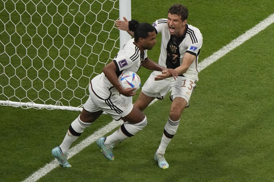 Germany's Serge Gnabry, left, celebrates with Germany's Thomas Mueller after scoring the opening goal during the World Cup group E soccer match between Costa Rica and Germany at the Al Bayt Stadium in Al Khor, Qatar, Thursday, Dec. 1, 2022. (AP Photo/Ariel Schalit)