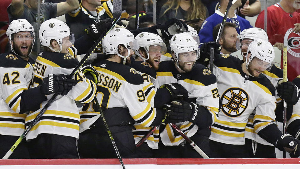 FILE - In this May 16, 2019, file photo, Boston Bruins players celebrate during the closing moments in Game 4 of the team's NHL hockey Stanley Cup Eastern Conference final victory over against the Carolina Hurricanes in Raleigh, N.C. The Bruins will face the St. Louis Blues in Game 1 of the Stanley Cup Final on Monday, May 27, 2019, in Boston. (AP Photo/Gerry Broome, File)