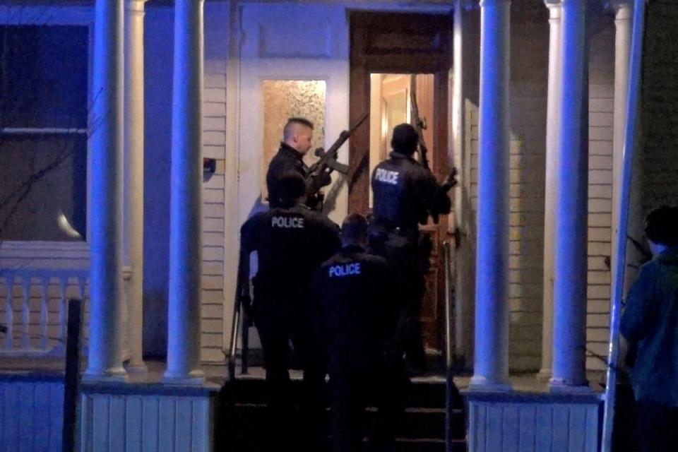 Police search a house in the neighbourhood after a gunman shot and wounded three college students of Palestinian descent in Vermont (via REUTERS)