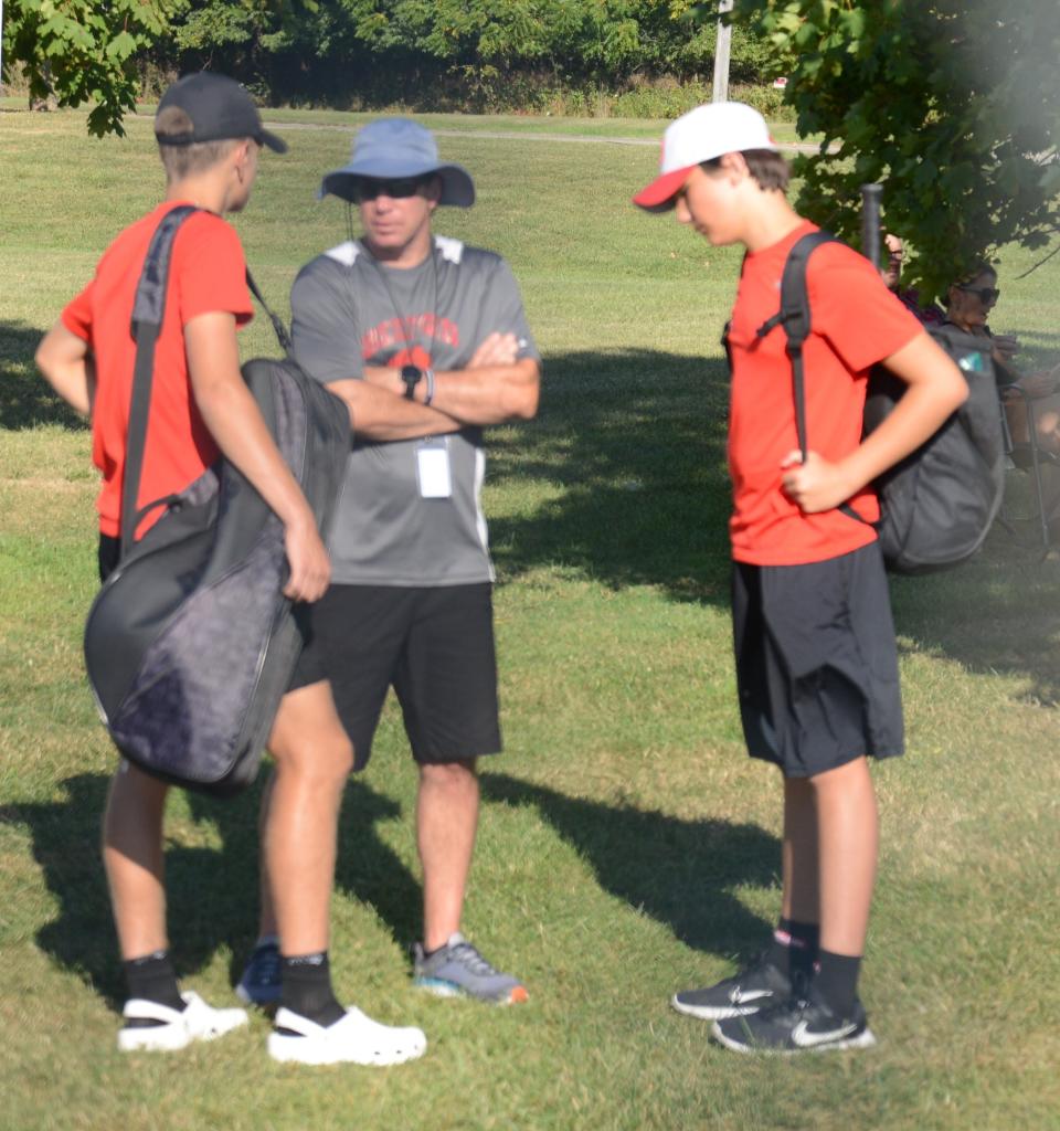 Bedford coach Eric Cukierski talks to his No. 2 doubles team of Carter Ryan and Taylor Burgermeister earlier this season.