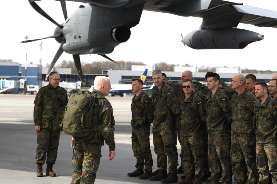 German Bundeswehr soldiers of the Headquarters initial command element of the Bundeswehr's 45th Brigade Lithuania arrive at an airport in Vilnius, Lithuania, Monday, April 8, 2024. Germany has made a commitment to deploy a heavy brigade with three maneuver battalions and all necessary enablers, including combat support and provision units, to Lithuania. In total, approx. 5 thousand German military and civilian personnel are expected to move to Lithuania with families in stationing the Brigade. (AP Photo/Mindaugas Kulbis)