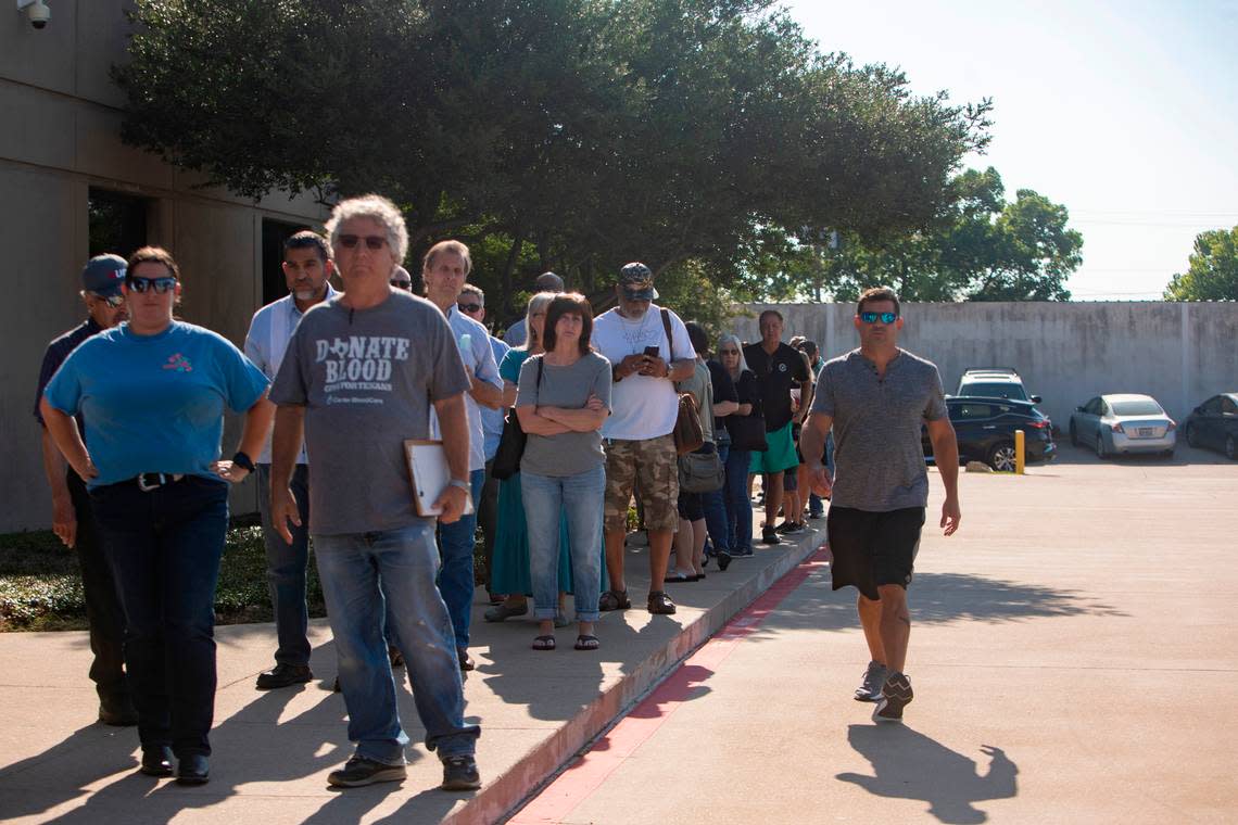 Hundreds of supporters waited outside of Tarrant Appraisal District to support Chandler Crouch during an emergency board meeting on Thursday, June 30, 2022, in Fort Worth, Texas. However, the meeting room sat only 14 people, leaving dozens waiting in the sun or exiting the line before they spoke.