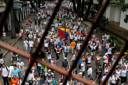 Demonstrators take part in a rally to honour victims of violence during a protest against Venezuela's President Nicolas Maduro's government in Caracas, Venezuela, April 22, 2017. REUTERS/Carlos Garcia Rawlins