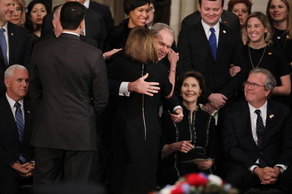 13) George W. Bush embraces Nancy Pelosi.