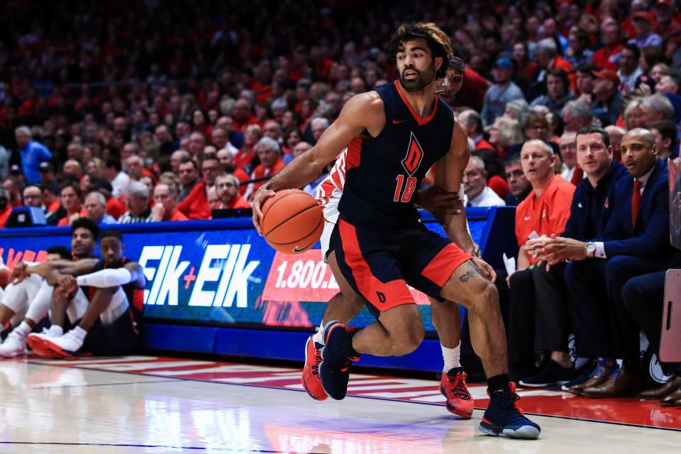 Duquesne's Sincere Carry (10) controls the ball against Dayton's Rodney Chatman in the first half, Saturday, Feb. 22, 2020, in Dayton.